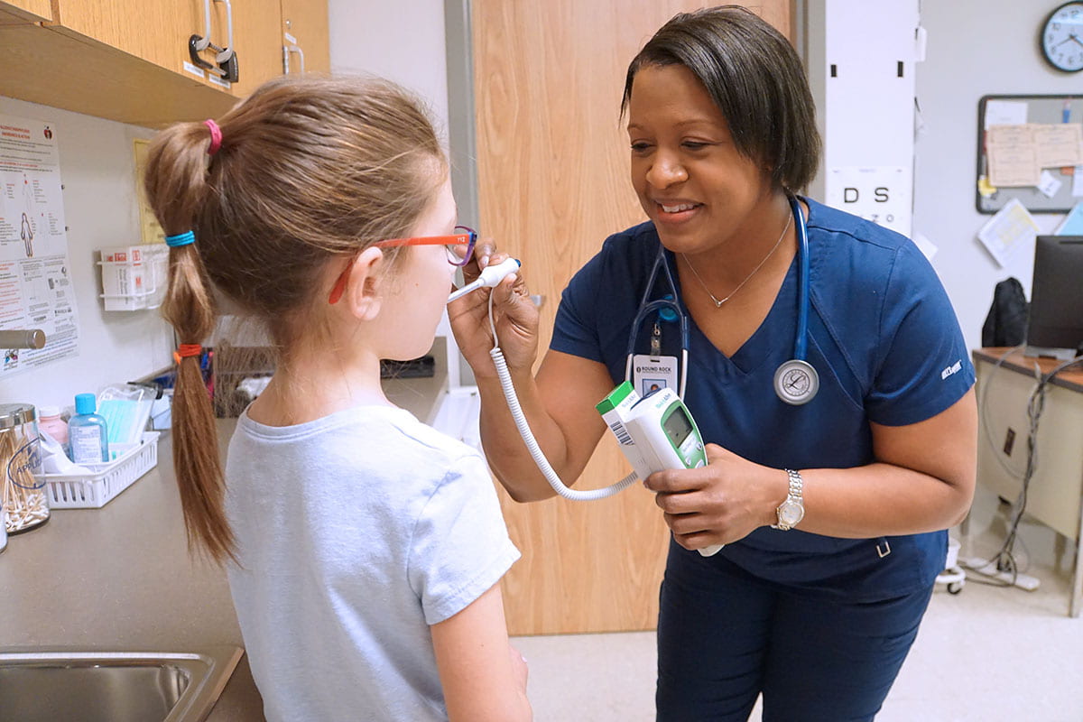 Sommer Elementary nurse taking a student's temperature