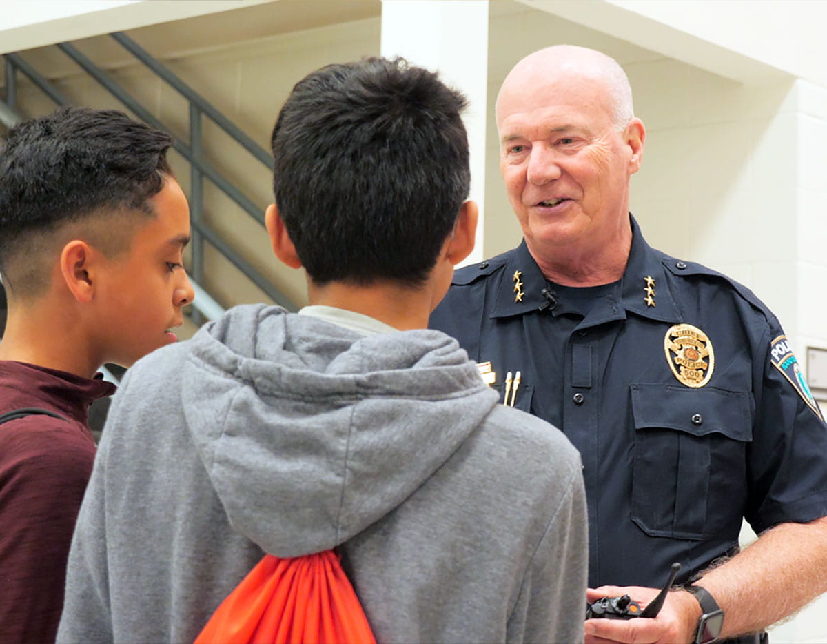 Chief of Police talking with students in hallway